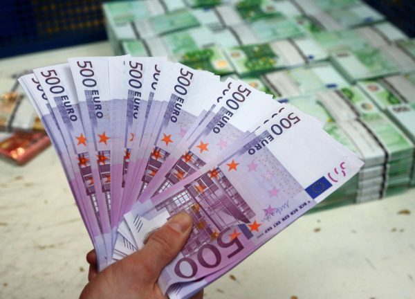An employee holds 500 euro banknotes in the Money Service Austria company's headquarters in Vienna